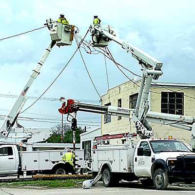 Marion city workers replace power lines and utility poles April 23. Jacob Hird of the city's electric department said the work was unrelated to the previous night's thunderstorm. "We were just doing regular pole maintenance," Hird said. "They get old and they start to rot at the bottom."